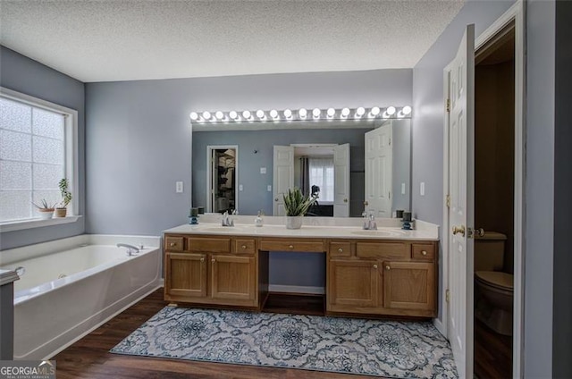 2908 Cottesford Way, Smyrna, GA 30080 - full bath featuring double vanity, wood finished floors, a garden tub, toilet, and a textured ceiling