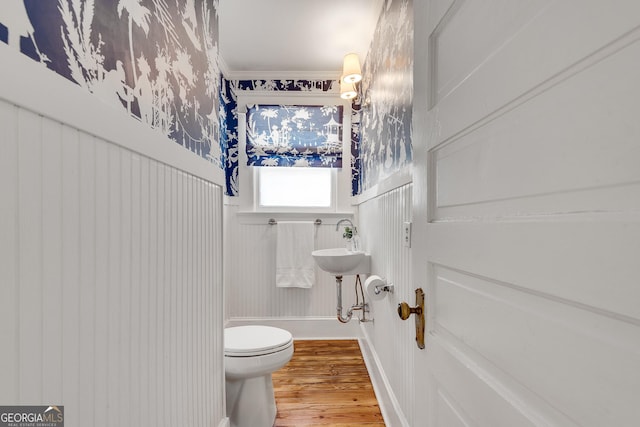 1157 Alta Ave NE, Atlanta, GA 30307 - bathroom featuring wood finished floors, toilet, ornamental molding, and a wainscoted wall