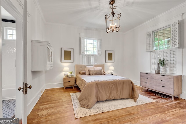 1157 Alta Ave NE, Atlanta, GA 30307 - bedroom with light wood-type flooring, crown molding, a chandelier, and baseboards
