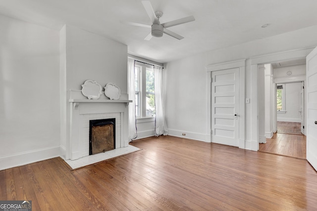 1157 Alta Ave NE, Atlanta, GA 30307 - unfurnished living room featuring a fireplace, a ceiling fan, light wood finished floors, and baseboards