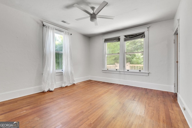 1157 Alta Ave NE, Atlanta, GA 30307 - unfurnished room featuring light wood-style flooring, plenty of natural light, ceiling fan, and baseboards