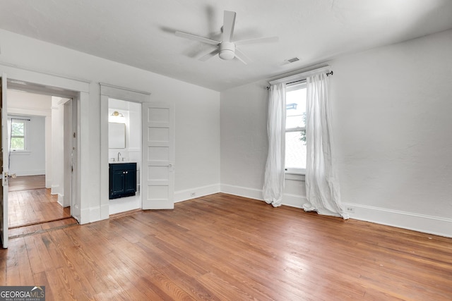 1157 Alta Ave NE, Atlanta, GA 30307 - empty room with plenty of natural light, light wood-style flooring, ceiling fan, and baseboards