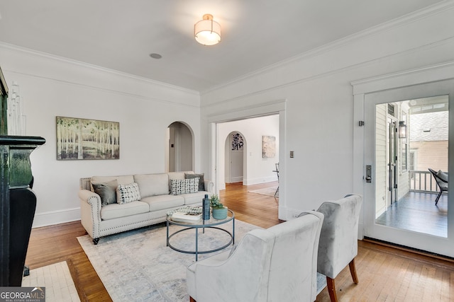 1157 Alta Ave NE, Atlanta, GA 30307 - living room with arched walkways, crown molding, hardwood / wood-style floors, and baseboards