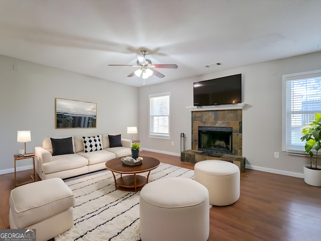 2918 Pavia Cir, Austell, GA 30106 - living room featuring baseboards, wood finished floors, ceiling fan, and a tiled fireplace