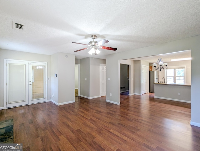 2918 Pavia Cir, Austell, GA 30106 - unfurnished living room with a chandelier, dark wood-type flooring, a ceiling fan, baseboards, and a textured ceiling