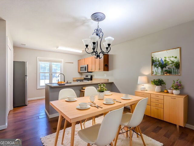 2918 Pavia Cir, Austell, GA 30106 - dining area with dark wood-type flooring, a chandelier, and baseboards