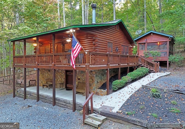 151 Hatchet Trl, Cherry Log, GA 30522 - rear view of property featuring log siding, a wooden deck, a patio area, and a view of trees