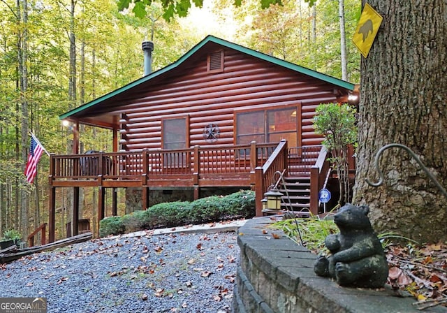 151 Hatchet Trl, Cherry Log, GA 30522 - rear view of house with a deck, log exterior, and a wooded view