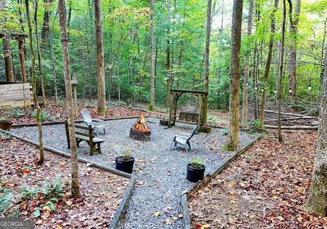 151 Hatchet Trl, Cherry Log, GA 30522 - view of yard featuring an outdoor fire pit and a forest view