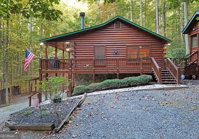 151 Hatchet Trl, Cherry Log, GA 30522 - back of property with log siding, stairway, a wooden deck, and a view of trees