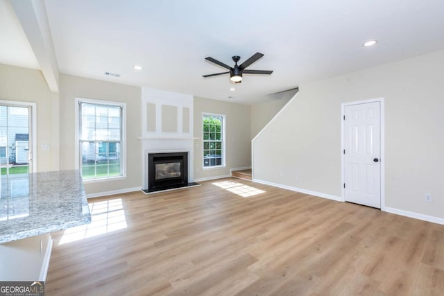 2915 Commonwealth Cir, Alpharetta, GA 30004 - unfurnished living room featuring a ceiling fan, plenty of natural light, light wood-type flooring, baseboards, and recessed lighting