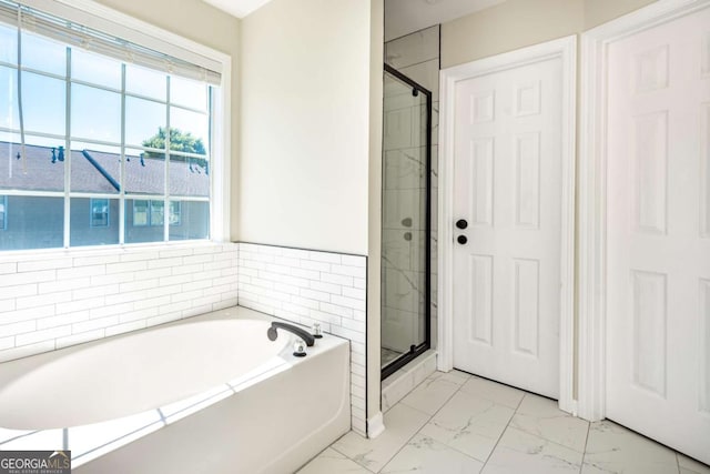 2915 Commonwealth Cir, Alpharetta, GA 30004 - bathroom featuring marble look tile flooring, a garden tub, and a shower stall