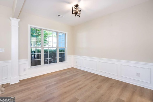 2915 Commonwealth Cir, Alpharetta, GA 30004 - empty room with wood finished floors, wainscoting, ornate columns, and a decorative wall