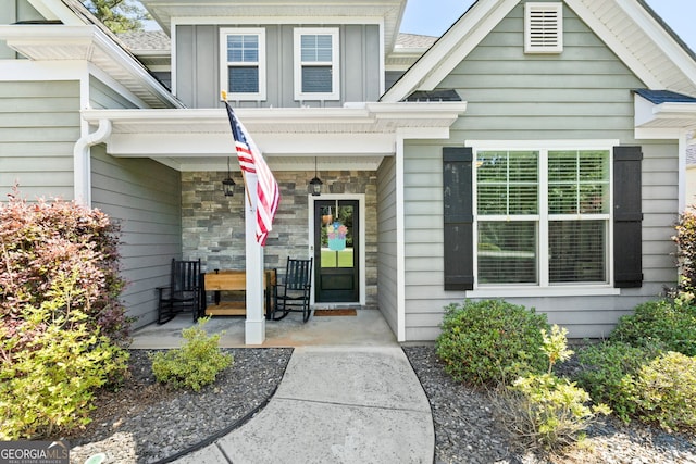 130 Edgewater Trl, Fayetteville, GA 30215 - property entrance with a porch, stone siding, and board and batten siding