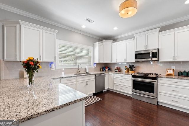 130 Edgewater Trl, Fayetteville, GA 30215 - kitchen featuring stainless steel appliances, a sink, white cabinets, crown molding, and tasteful backsplash