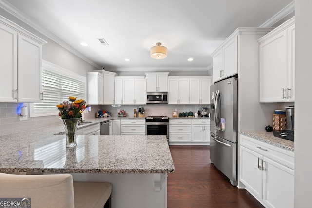 130 Edgewater Trl, Fayetteville, GA 30215 - kitchen with appliances with stainless steel finishes, a peninsula, white cabinets, crown molding, and backsplash