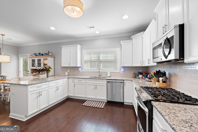 130 Edgewater Trl, Fayetteville, GA 30215 - kitchen featuring appliances with stainless steel finishes, a sink, a peninsula, white cabinets, and tasteful backsplash