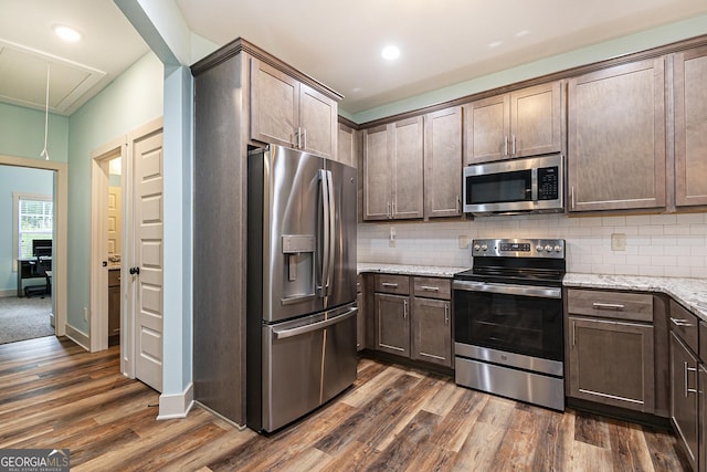 562 Yonah Lake Dr, Sautee Nacoochee, GA 30571 - kitchen featuring stainless steel appliances, dark wood-type flooring, backsplash, dark brown cabinetry, and light stone counters