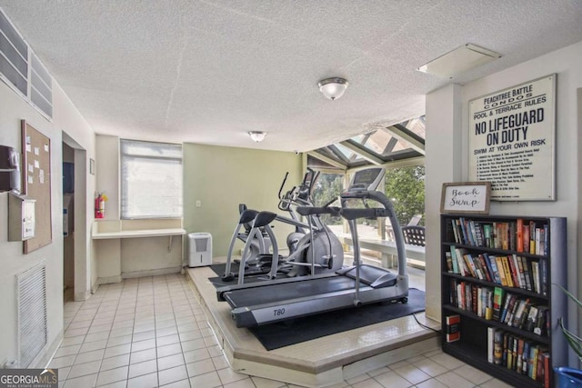 2285 Peachtree Rd NE, Atlanta, GA 30309 - exercise room with a textured ceiling, plenty of natural light, and tile patterned floors