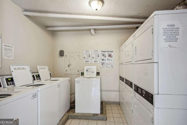 2285 Peachtree Rd NE, Atlanta, GA 30309 - shared laundry with stacked washer / drying machine, separate washer and dryer, a textured ceiling, and light tile patterned flooring
