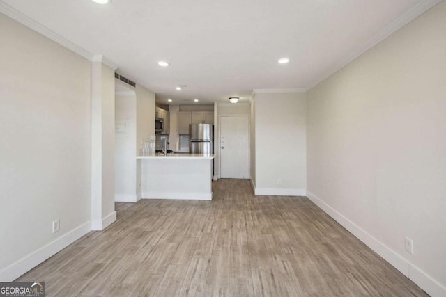 2285 Peachtree Rd NE, Atlanta, GA 30309 - unfurnished living room with recessed lighting, baseboards, ornamental molding, light wood-type flooring, and a sink