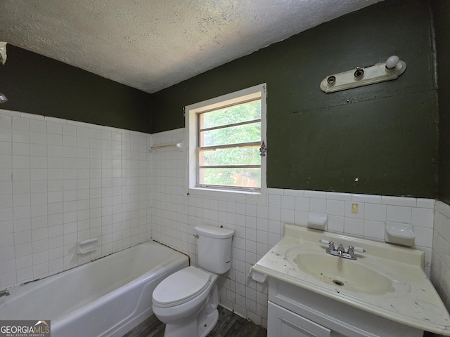 4274 Kimball Rd SW, Atlanta, GA 30331 - bathroom featuring a textured ceiling, vanity, tile walls, toilet, and wood finished floors