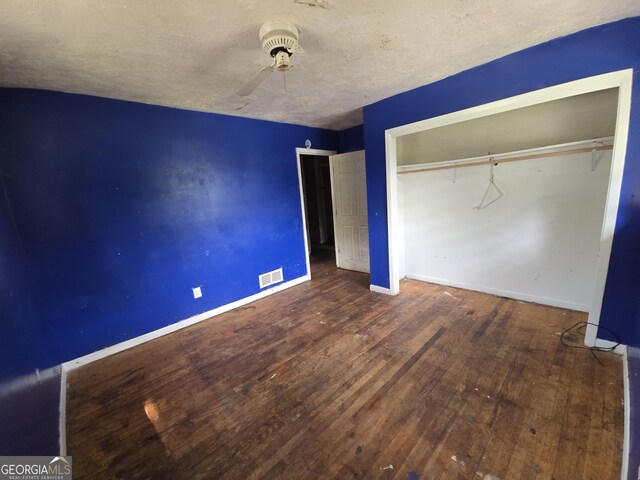 4274 Kimball Rd SW, Atlanta, GA 30331 - unfurnished bedroom with baseboards, hardwood / wood-style flooring, a ceiling fan, a closet, and a textured ceiling
