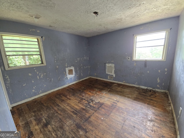 4274 Kimball Rd SW, Atlanta, GA 30331 - unfurnished room featuring hardwood / wood-style floors, heating unit, a textured ceiling, and baseboards