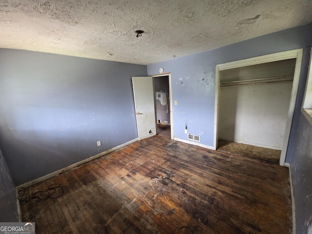 4274 Kimball Rd SW, Atlanta, GA 30331 - unfurnished bedroom featuring hardwood / wood-style floors, a textured ceiling, a closet, and baseboards