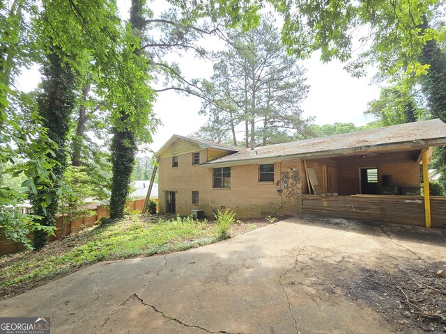 4274 Kimball Rd SW, Atlanta, GA 30331 - back of property with an attached carport, driveway, and central AC