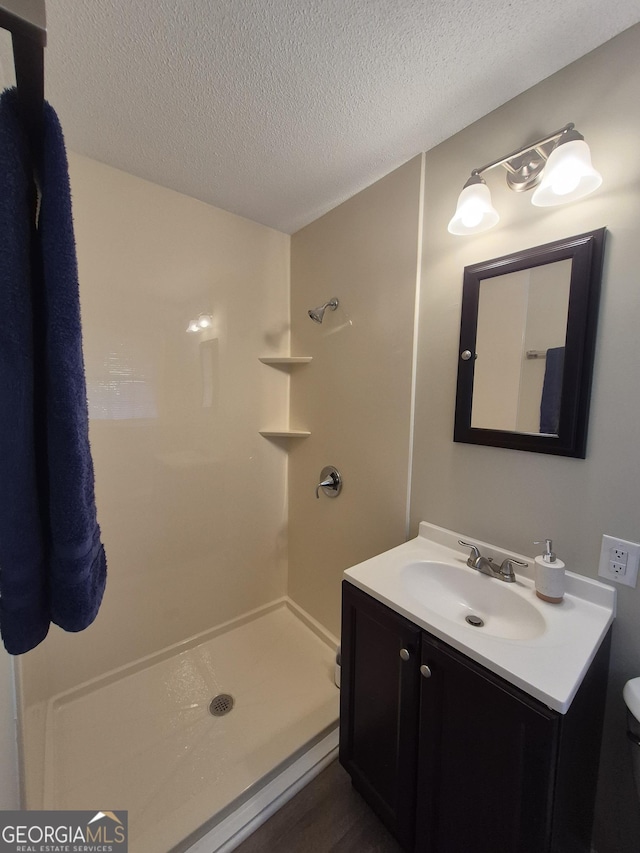 116 Cherokee Rdg, Athens, GA 30606 - bathroom featuring vanity, a shower, and a textured ceiling