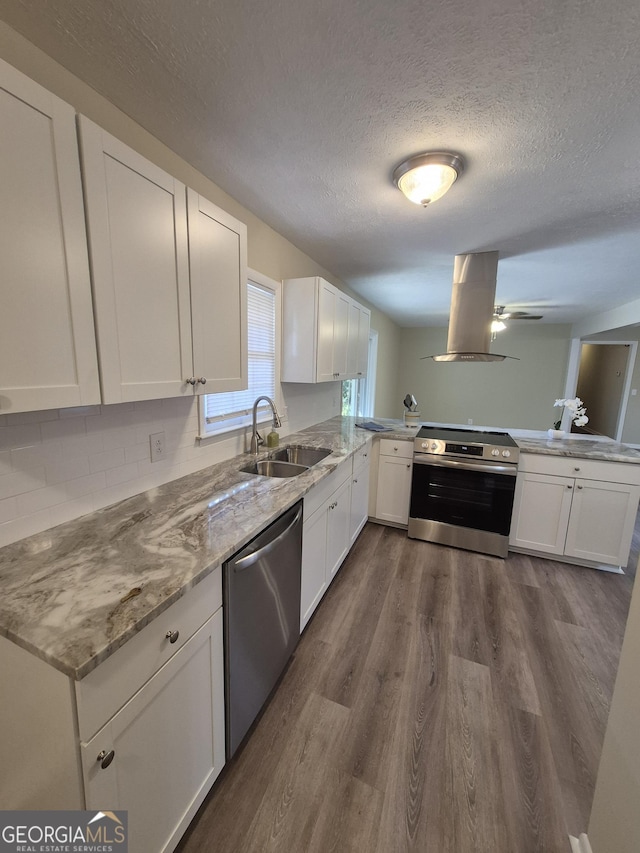 116 Cherokee Rdg, Athens, GA 30606 - kitchen with stainless steel appliances, island exhaust hood, a peninsula, a textured ceiling, and dark wood-style flooring