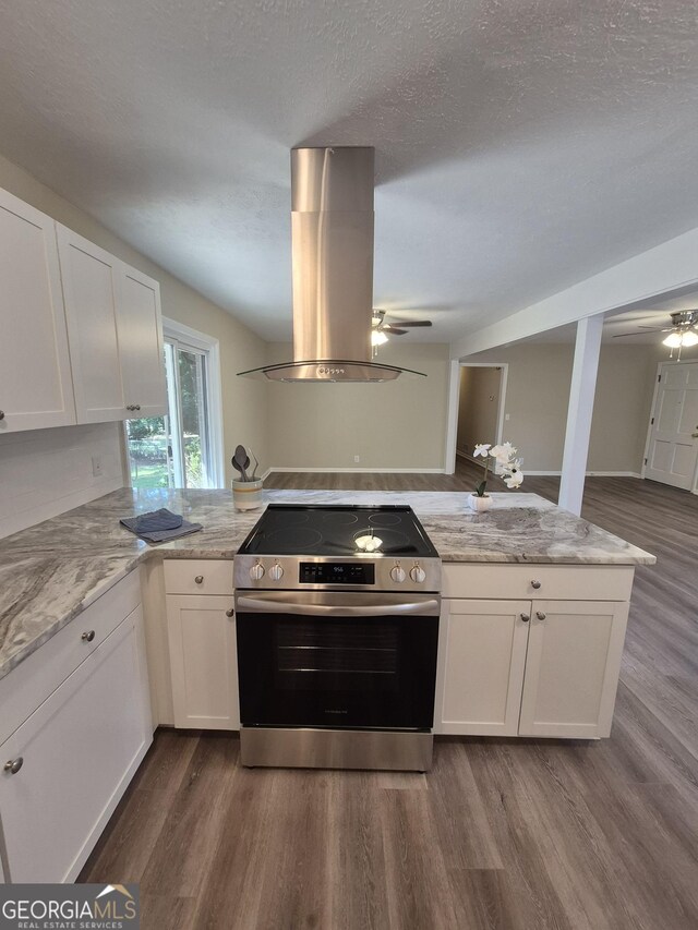 116 Cherokee Rdg, Athens, GA 30606 - kitchen with electric stove, a ceiling fan, island range hood, dark wood finished floors, and white cabinets