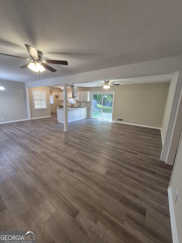 116 Cherokee Rdg, Athens, GA 30606 - unfurnished living room featuring ceiling fan, dark wood-style flooring, and a textured ceiling