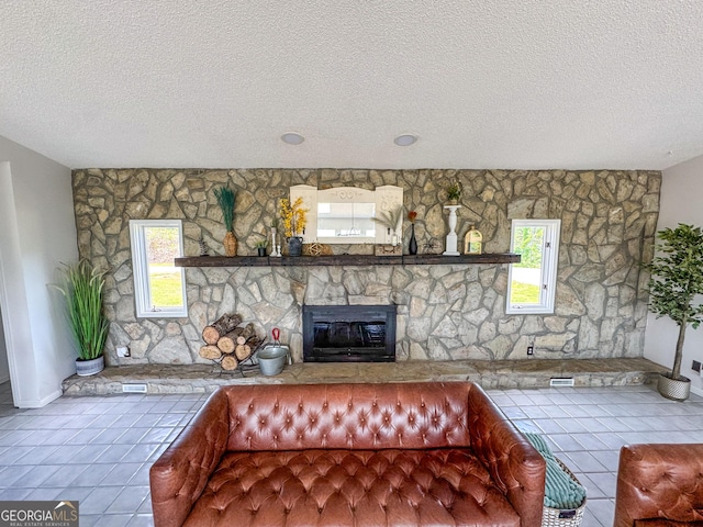 134 Roy Dean Rd, Buchanan, GA 30113 - unfurnished living room featuring a fireplace, a textured ceiling, tile patterned floors, and baseboards