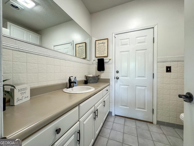 134 Roy Dean Rd, Buchanan, GA 30113 - bathroom featuring tile walls, tile patterned floors, vanity, toilet, and a textured ceiling
