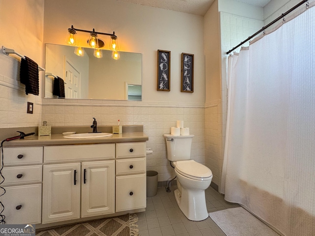 134 Roy Dean Rd, Buchanan, GA 30113 - full bathroom with tile patterned floors, toilet, tile walls, vanity, and wainscoting