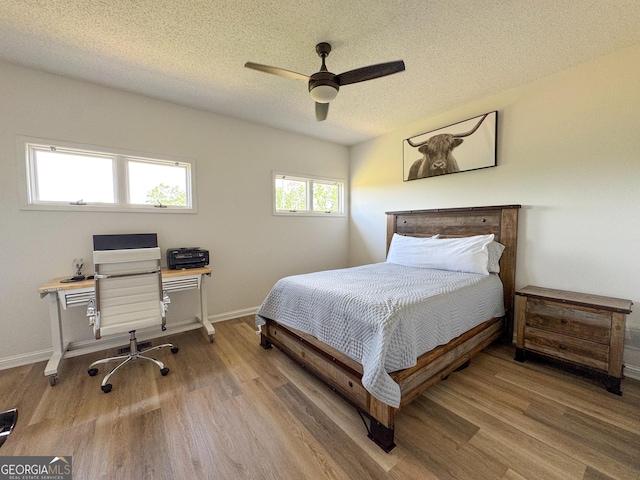 134 Roy Dean Rd, Buchanan, GA 30113 - bedroom with wood finished floors, a textured ceiling, baseboards, ceiling fan, and an office area