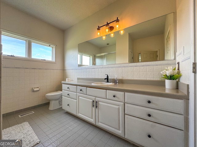 134 Roy Dean Rd, Buchanan, GA 30113 - bathroom featuring tile walls, tile patterned flooring, vanity, toilet, and an enclosed shower