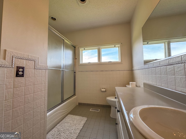 134 Roy Dean Rd, Buchanan, GA 30113 - bathroom with tile walls, tile patterned floors, toilet, a textured ceiling, and vanity