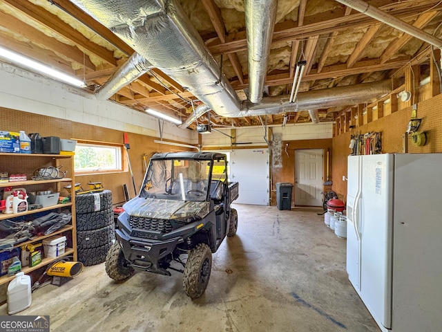 134 Roy Dean Rd, Buchanan, GA 30113 - garage with white fridge with ice dispenser and a garage door opener