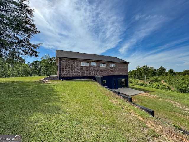 134 Roy Dean Rd, Buchanan, GA 30113 - back of house featuring a lawn, an attached garage, and brick siding