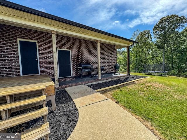 134 Roy Dean Rd, Buchanan, GA 30113 - doorway to property with a lawn, a patio, and brick siding