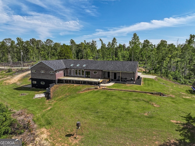 134 Roy Dean Rd, Buchanan, GA 30113 - view of front facade with a front yard, a wooden deck, and a view of trees