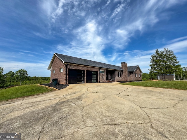 134 Roy Dean Rd, Buchanan, GA 30113 - view of front facade featuring brick siding, concrete driveway, a garage, a chimney, and a front lawn