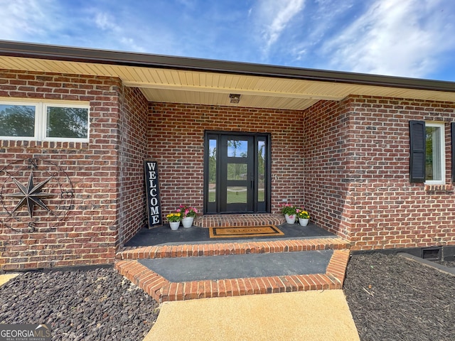 134 Roy Dean Rd, Buchanan, GA 30113 - view of exterior entry featuring brick siding and a porch