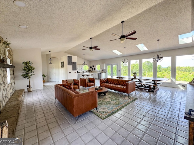134 Roy Dean Rd, Buchanan, GA 30113 - living room featuring a skylight, lofted ceiling, a textured ceiling, tile patterned flooring, and a ceiling fan