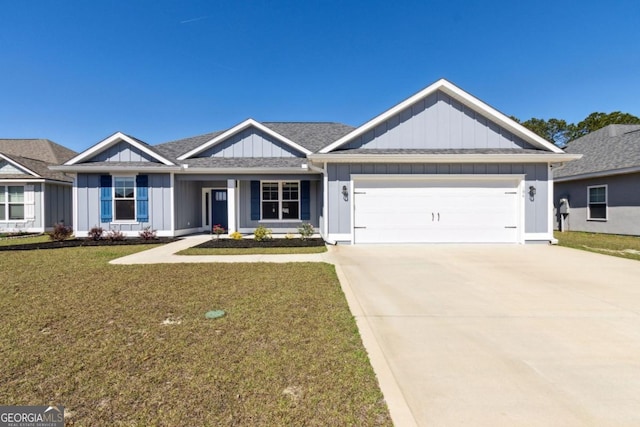 194 Pistachio Ln, Kingsland, GA 31548 - view of front facade featuring board and batten siding, a garage, a front lawn, and concrete driveway