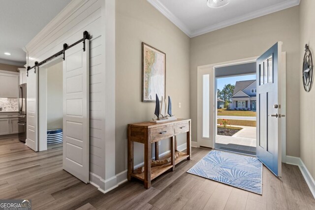 194 Pistachio Ln, Kingsland, GA 31548 - foyer with ornamental molding, a barn door, light wood-style flooring, baseboards, and recessed lighting