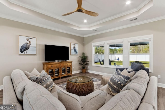 194 Pistachio Ln, Kingsland, GA 31548 - living room with a raised ceiling, wood finished floors, baseboards, ornamental molding, and ceiling fan